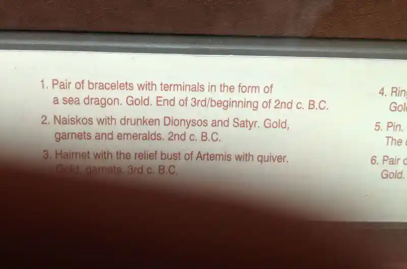 Gold naiskos with relief of drunken Dionysos and Satyr decorated with garnets and emeralds